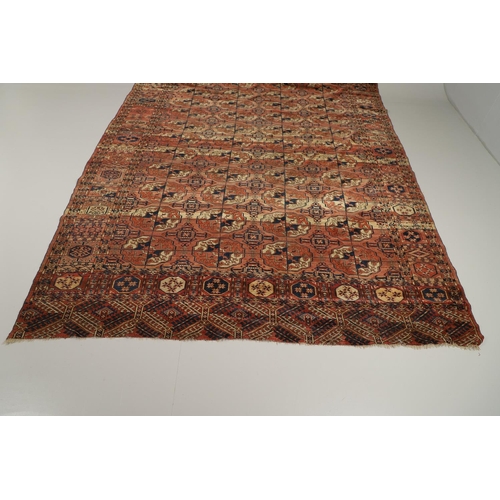 1312 - A TEKKE TURKMAN RUG, EMIRATE OF BUKHARA, CIRCA 1890. the madder field with four columns of guls encl... 