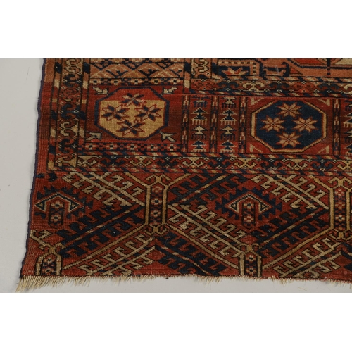 1312 - A TEKKE TURKMAN RUG, EMIRATE OF BUKHARA, CIRCA 1890. the madder field with four columns of guls encl... 