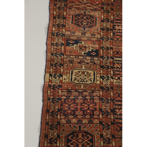 1312 - A TEKKE TURKMAN RUG, EMIRATE OF BUKHARA, CIRCA 1890. the madder field with four columns of guls encl... 