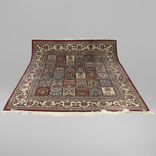 1314 - AN INDIAN CARPET OF UNUSUAL SIZE, CIRCA 1980. the compartmentalised polychrome field of plants and f... 