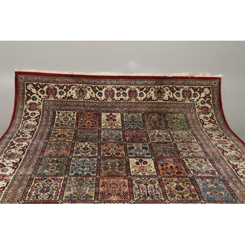 1314 - AN INDIAN CARPET OF UNUSUAL SIZE, CIRCA 1980. the compartmentalised polychrome field of plants and f... 