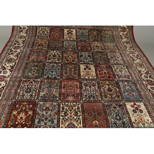 1314 - AN INDIAN CARPET OF UNUSUAL SIZE, CIRCA 1980. the compartmentalised polychrome field of plants and f... 