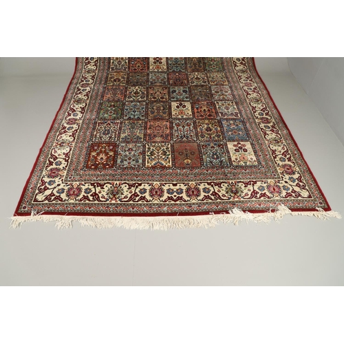 1314 - AN INDIAN CARPET OF UNUSUAL SIZE, CIRCA 1980. the compartmentalised polychrome field of plants and f... 