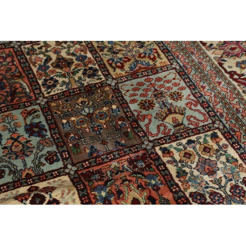 1314 - AN INDIAN CARPET OF UNUSUAL SIZE, CIRCA 1980. the compartmentalised polychrome field of plants and f... 