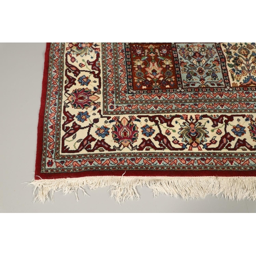 1314 - AN INDIAN CARPET OF UNUSUAL SIZE, CIRCA 1980. the compartmentalised polychrome field of plants and f... 