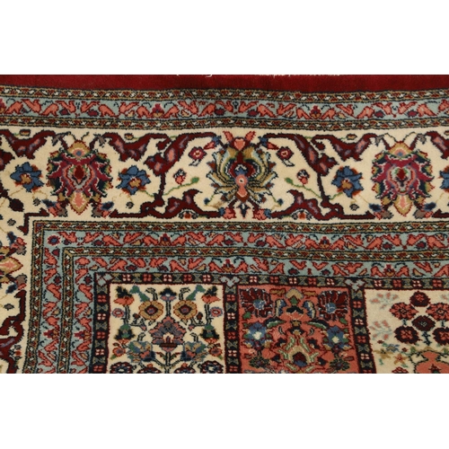 1314 - AN INDIAN CARPET OF UNUSUAL SIZE, CIRCA 1980. the compartmentalised polychrome field of plants and f... 