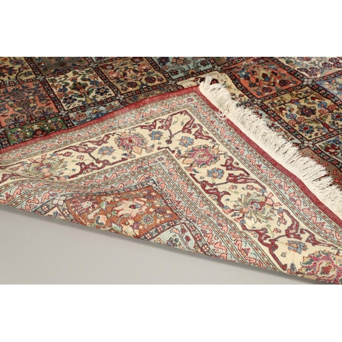 1314 - AN INDIAN CARPET OF UNUSUAL SIZE, CIRCA 1980. the compartmentalised polychrome field of plants and f... 