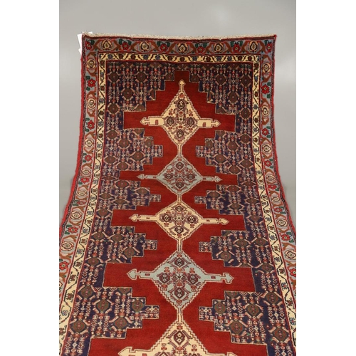 1318 - A SENNEH RUNNER, PERSIAN KURDISTAN, CIRCA 1980. the field with a column of winged diamond medallions... 