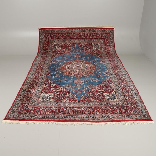 1319 - AN ORIENTAL CARPET, THIRD QUARTER 20TH CENTURY. the sky blue field with flower head medallion framed... 