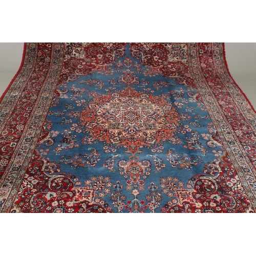 1319 - AN ORIENTAL CARPET, THIRD QUARTER 20TH CENTURY. the sky blue field with flower head medallion framed... 