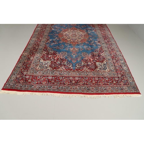 1319 - AN ORIENTAL CARPET, THIRD QUARTER 20TH CENTURY. the sky blue field with flower head medallion framed... 