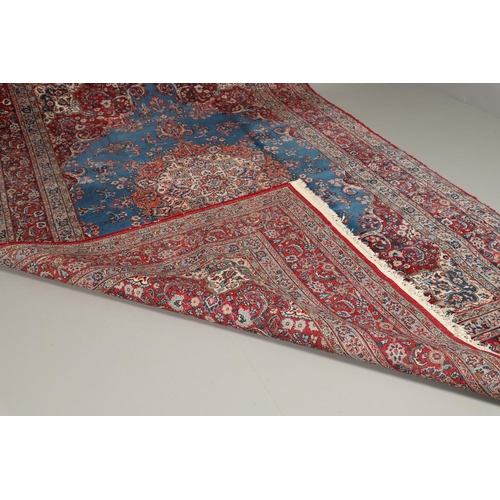 1319 - AN ORIENTAL CARPET, THIRD QUARTER 20TH CENTURY. the sky blue field with flower head medallion framed... 