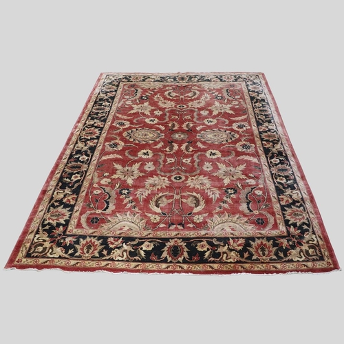 1320 - A MODERN AFGHAN 'ZIEGLER' CARPET. the salmon pink field of serrated leaves and flower heads enclosed... 