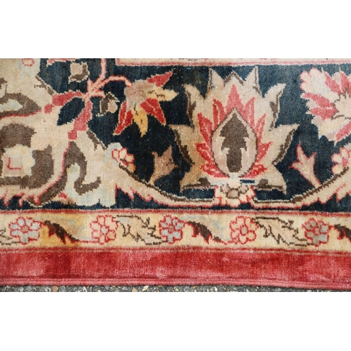 1320 - A MODERN AFGHAN 'ZIEGLER' CARPET. the salmon pink field of serrated leaves and flower heads enclosed... 