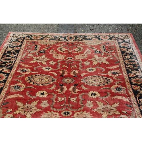 1320 - A MODERN AFGHAN 'ZIEGLER' CARPET. the salmon pink field of serrated leaves and flower heads enclosed... 