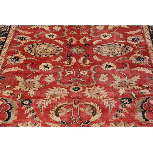 1320 - A MODERN AFGHAN 'ZIEGLER' CARPET. the salmon pink field of serrated leaves and flower heads enclosed... 