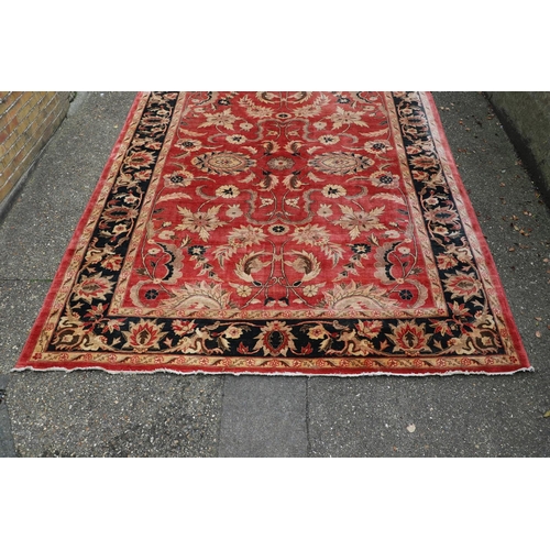 1320 - A MODERN AFGHAN 'ZIEGLER' CARPET. the salmon pink field of serrated leaves and flower heads enclosed... 