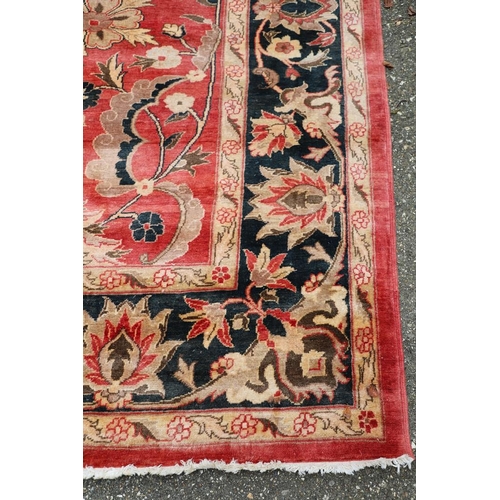 1320 - A MODERN AFGHAN 'ZIEGLER' CARPET. the salmon pink field of serrated leaves and flower heads enclosed... 