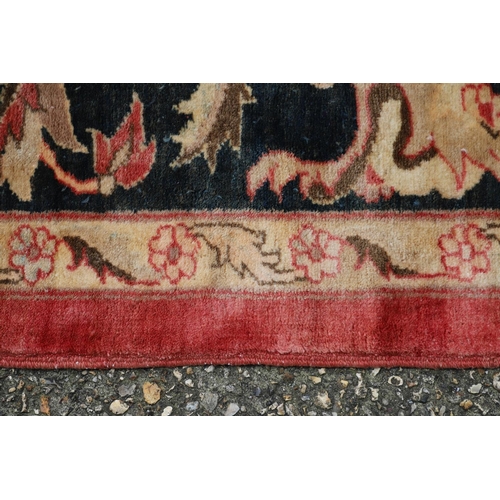 1320 - A MODERN AFGHAN 'ZIEGLER' CARPET. the salmon pink field of serrated leaves and flower heads enclosed... 