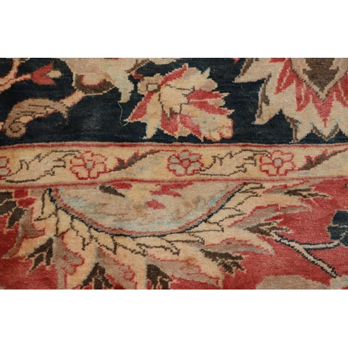 1320 - A MODERN AFGHAN 'ZIEGLER' CARPET. the salmon pink field of serrated leaves and flower heads enclosed... 