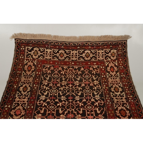 1321 - A KONAKEND RUG, NORTH EAST CAUCASUS, CIRCA 1900. the charcoal field of angular vines enclosed by Kuf... 