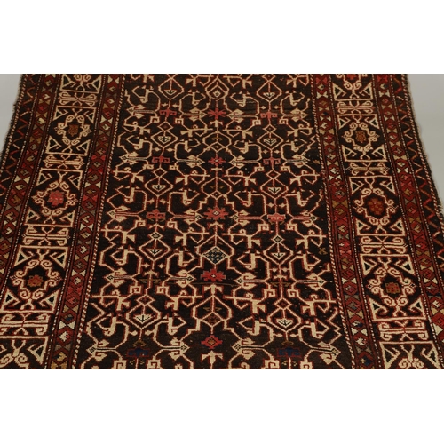 1321 - A KONAKEND RUG, NORTH EAST CAUCASUS, CIRCA 1900. the charcoal field of angular vines enclosed by Kuf... 