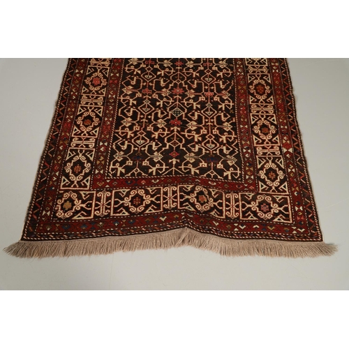 1321 - A KONAKEND RUG, NORTH EAST CAUCASUS, CIRCA 1900. the charcoal field of angular vines enclosed by Kuf... 