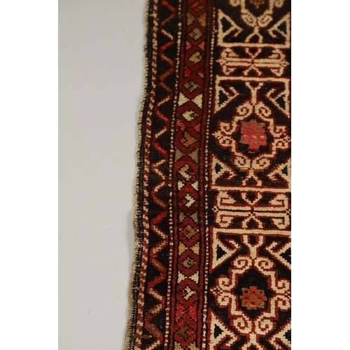 1321 - A KONAKEND RUG, NORTH EAST CAUCASUS, CIRCA 1900. the charcoal field of angular vines enclosed by Kuf... 