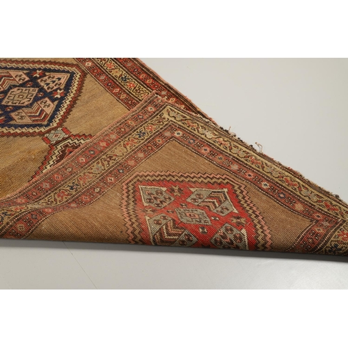 1324 - A NORTH WEST PERSIAN RUNNER, CIRCA 1900. the camel ground with a column of stepped diamond medallion... 