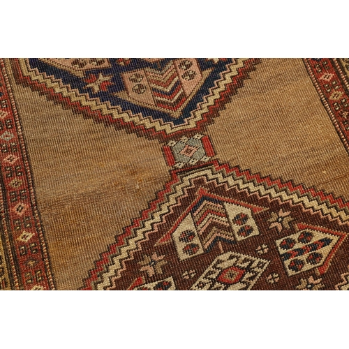 1324 - A NORTH WEST PERSIAN RUNNER, CIRCA 1900. the camel ground with a column of stepped diamond medallion... 