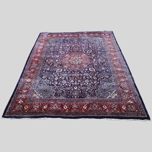 1325 - A PERSIAN SAROUKH CARPET, CIRCA 1970. the deep indigo field of scrolling vines and flowers centred b... 