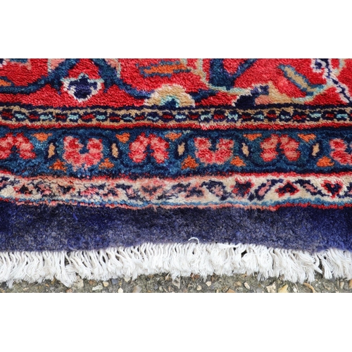 1325 - A PERSIAN SAROUKH CARPET, CIRCA 1970. the deep indigo field of scrolling vines and flowers centred b... 