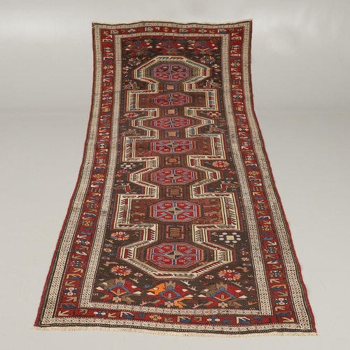 1327 - AN EAST CAUCASIAN RUG, CIRCA 1900. the charcoal field with central panel containing a column of hook... 