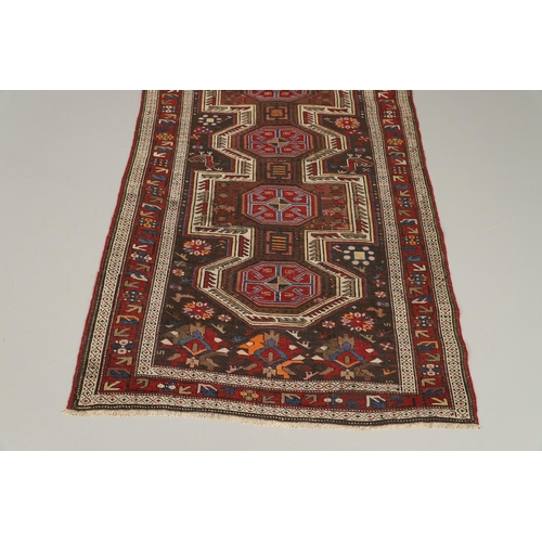 1327 - AN EAST CAUCASIAN RUG, CIRCA 1900. the charcoal field with central panel containing a column of hook... 