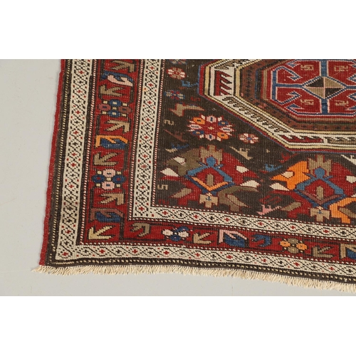 1327 - AN EAST CAUCASIAN RUG, CIRCA 1900. the charcoal field with central panel containing a column of hook... 