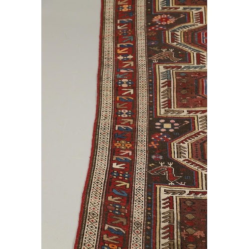 1327 - AN EAST CAUCASIAN RUG, CIRCA 1900. the charcoal field with central panel containing a column of hook... 