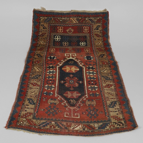 1329 - A KAZAK RUG, CENTRAL CAUCASUS, CIRCA 1910. the madder field with two panels containing geometric mot... 