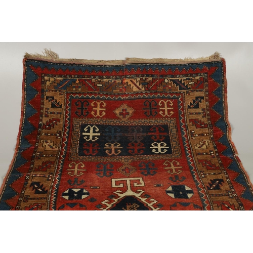 1329 - A KAZAK RUG, CENTRAL CAUCASUS, CIRCA 1910. the madder field with two panels containing geometric mot... 