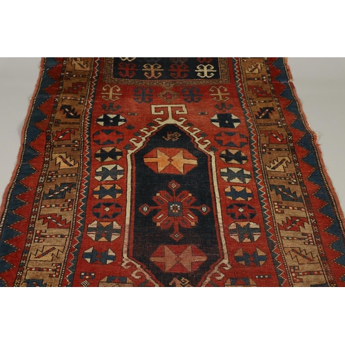 1329 - A KAZAK RUG, CENTRAL CAUCASUS, CIRCA 1910. the madder field with two panels containing geometric mot... 