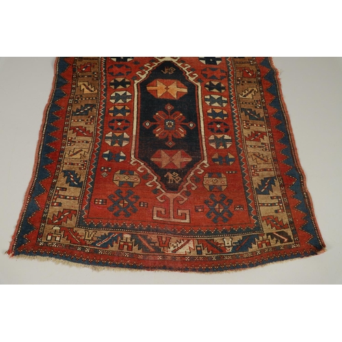 1329 - A KAZAK RUG, CENTRAL CAUCASUS, CIRCA 1910. the madder field with two panels containing geometric mot... 