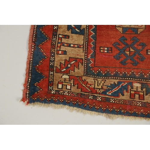 1329 - A KAZAK RUG, CENTRAL CAUCASUS, CIRCA 1910. the madder field with two panels containing geometric mot... 