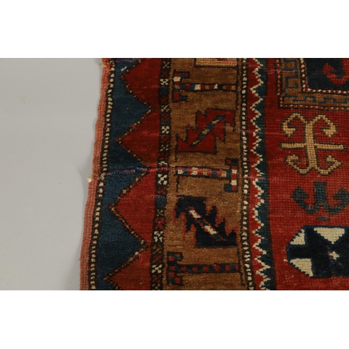 1329 - A KAZAK RUG, CENTRAL CAUCASUS, CIRCA 1910. the madder field with two panels containing geometric mot... 