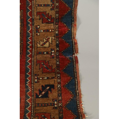 1329 - A KAZAK RUG, CENTRAL CAUCASUS, CIRCA 1910. the madder field with two panels containing geometric mot... 