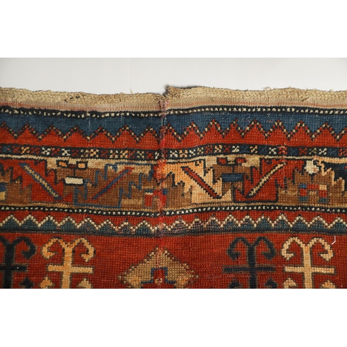 1329 - A KAZAK RUG, CENTRAL CAUCASUS, CIRCA 1910. the madder field with two panels containing geometric mot... 