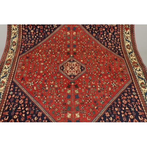 1330 - AN ABADEH RUG, SOUTH PERSIA, CIRCA 1980. the brick field of tribal devices centred by framed by span... 