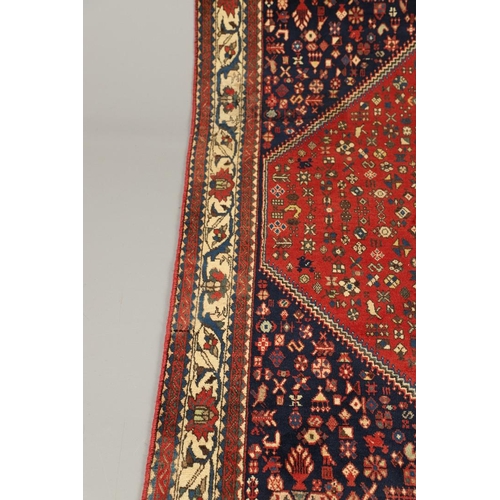 1330 - AN ABADEH RUG, SOUTH PERSIA, CIRCA 1980. the brick field of tribal devices centred by framed by span... 