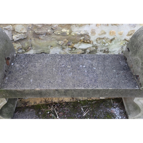 1333 - A PAIR OF CARVED STONE GARDEN BENCHES. with scroll end supports to a rectangular seat, upon arched p... 