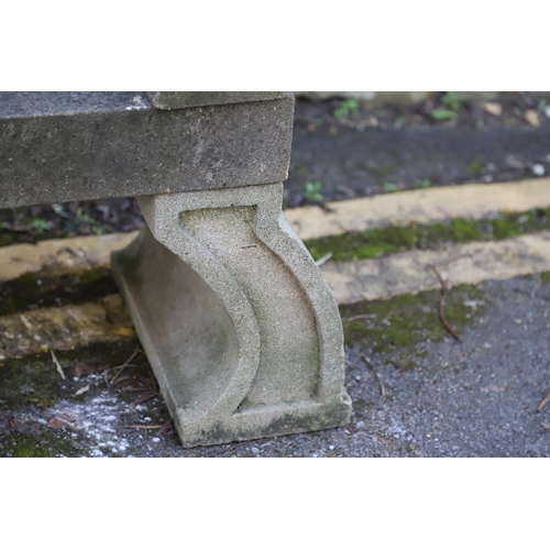 1333 - A PAIR OF CARVED STONE GARDEN BENCHES. with scroll end supports to a rectangular seat, upon arched p... 