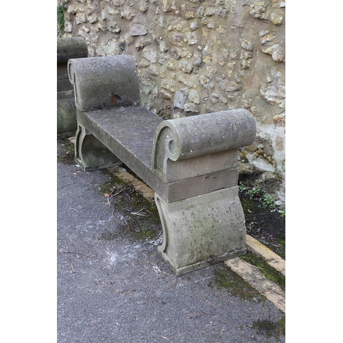 1333 - A PAIR OF CARVED STONE GARDEN BENCHES. with scroll end supports to a rectangular seat, upon arched p... 