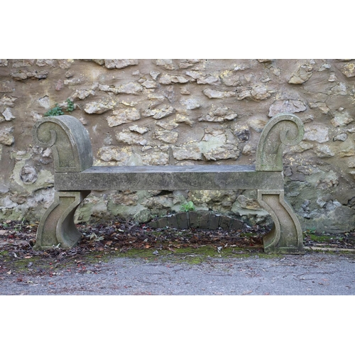 1333 - A PAIR OF CARVED STONE GARDEN BENCHES. with scroll end supports to a rectangular seat, upon arched p... 